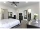 Spacious main bedroom with ceiling fan, a walk-in closet, and black wood furniture at 1455 E Dove Pl, Casa Grande, AZ 85122