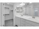 Elegant bathroom with double vanity, closet, and great lighting at 14628 W Sand Hills Rd, Surprise, AZ 85387