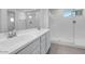 Bright bathroom featuring double vanity, shower, and sleek fixtures at 14628 W Sand Hills Rd, Surprise, AZ 85387
