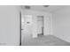 Cozy bedroom featuring carpeted floors, closet, and bright lighting at 14628 W Sand Hills Rd, Surprise, AZ 85387