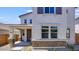 Inviting home exterior with brick accents, covered porch, and manicured landscaping at 14628 W Sand Hills Rd, Surprise, AZ 85387