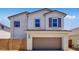 Charming two-story home featuring a stucco exterior, a two-car garage, and shutters at 14628 W Sand Hills Rd, Surprise, AZ 85387