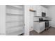 Well-organized kitchen showcasing white cabinetry, sleek appliances, and a pantry at 14628 W Sand Hills Rd, Surprise, AZ 85387