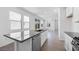 Open kitchen with a granite countertop island that flows into the living room area at 14628 W Sand Hills Rd, Surprise, AZ 85387