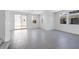 Expansive living room featuring gray tile floors and bright natural light at 14628 W Sand Hills Rd, Surprise, AZ 85387
