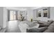 Open concept living area with tile floors, neutral colors, and access to the outdoors through sliding doors at 14628 W Sand Hills Rd, Surprise, AZ 85387