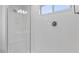 Modern walk-in shower features glass door, bench, and showerhead at 14628 W Sand Hills Rd, Surprise, AZ 85387