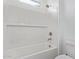 Bathroom featuring a white tiled shower and tub combination with modern fixtures at 15822 W Bronco Trl, Surprise, AZ 85387
