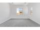 Light-filled bedroom with plush carpet and a view of the exterior at 15822 W Bronco Trl, Surprise, AZ 85387