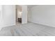 Bright bedroom with plush gray carpet and a view into the ensuite bathroom at 15822 W Bronco Trl, Surprise, AZ 85387