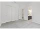 Bedroom with carpet flooring, closet, and view into the ensuite bathroom at 15822 W Bronco Trl, Surprise, AZ 85387