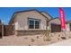 A single-story home with modern design and landscaping, showcasing a two-car garage and inviting entrance at 15822 W Bronco Trl, Surprise, AZ 85387