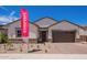 Inviting single-story home showcasing desert landscaping, a two-car garage and stylish accents at 15822 W Bronco Trl, Surprise, AZ 85387