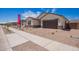 Charming single-story home with a desert landscape, a two-car garage, and a welcoming facade at 15822 W Bronco Trl, Surprise, AZ 85387