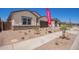 A single-story home with manicured desert landscaping, a two-car garage and modern accents at 15822 W Bronco Trl, Surprise, AZ 85387