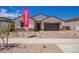 Charming single-story home with a two-car garage, desert landscaping, and paver driveway at 15822 W Bronco Trl, Surprise, AZ 85387