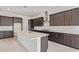 Modern kitchen features sleek stainless steel appliances and large center island at 15822 W Bronco Trl, Surprise, AZ 85387