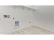 A minimalist laundry room featuring ample shelving and tile flooring, ready for appliances at 15822 W Bronco Trl, Surprise, AZ 85387