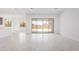 Spacious open-concept living area with large glass doors to the backyard at 15822 W Bronco Trl, Surprise, AZ 85387
