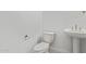This powder room features a pedestal sink, toilet, and neutral color palette at 15822 W Bronco Trl, Surprise, AZ 85387