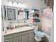 Bathroom featuring a granite countertop, gray-washed cabinets, and shower/tub combo with a patterned curtain at 17648 N 36Th St, Phoenix, AZ 85032