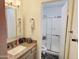 A small bathroom featuring granite countertops, gray-washed cabinets, and shower/tub combo at 17648 N 36Th St, Phoenix, AZ 85032