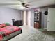 A bedroom with gray carpet, light purple walls, sliding glass door, and a ceiling fan at 17648 N 36Th St, Phoenix, AZ 85032