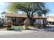 Single-story home features manicured front yard with decorative wooden well and arbor at 17648 N 36Th St, Phoenix, AZ 85032