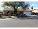 Ranch-style home boasts a well-maintained front yard, mature tree, and two-car garage at 17648 N 36Th St, Phoenix, AZ 85032