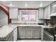 Well-lit kitchen featuring granite countertops and modern stainless steel appliances at 17648 N 36Th St, Phoenix, AZ 85032