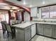 Open-concept kitchen with granite countertops and modern gray cabinets at 17648 N 36Th St, Phoenix, AZ 85032