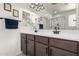 Bathroom features a double sink vanity with a glass enclosed walk-in shower at 18069 W Tina Ln, Surprise, AZ 85387