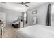 This bedroom features a ceiling fan and a work space with natural light from the window at 18069 W Tina Ln, Surprise, AZ 85387