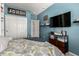 Bedroom with a walk in closet, dark wood dresser, and vibrant blue walls at 18069 W Tina Ln, Surprise, AZ 85387