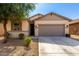 Charming single-story home featuring a neutral color scheme, well-maintained landscaping, and a spacious two-car garage at 18069 W Tina Ln, Surprise, AZ 85387