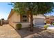 Charming single-story home featuring a neutral color scheme, well-maintained landscaping, and a spacious two-car garage at 18069 W Tina Ln, Surprise, AZ 85387