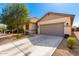 Charming single-story home featuring a neutral color scheme, well-maintained landscaping, and a spacious two-car garage at 18069 W Tina Ln, Surprise, AZ 85387