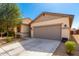 Charming single-story home featuring a neutral color scheme, well-maintained landscaping, and a spacious two-car garage at 18069 W Tina Ln, Surprise, AZ 85387