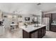Spacious kitchen area with a large island, modern appliances, and seamless flow into dining and living spaces at 18069 W Tina Ln, Surprise, AZ 85387