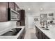 Stylish kitchen featuring white countertops, stainless steel appliances, dark wood cabinetry and a convenient pantry at 18069 W Tina Ln, Surprise, AZ 85387