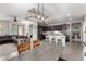 Spacious kitchen with a large center island, dark wood cabinetry, stainless steel appliances and a large hanging light fixture at 18069 W Tina Ln, Surprise, AZ 85387