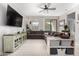 Inviting living room with a plush sectional sofa, stylish rug, ceiling fan, and plenty of space for relaxation and entertainment at 18069 W Tina Ln, Surprise, AZ 85387