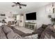 Inviting living room with a plush sectional sofa, stylish rug, ceiling fan, and plenty of space for relaxation and entertainment at 18069 W Tina Ln, Surprise, AZ 85387