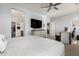 Bright main bedroom featuring a ceiling fan, neutral walls, and access to the bathroom and closet at 18069 W Tina Ln, Surprise, AZ 85387
