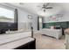 Bright main bedroom featuring green trim, natural light, and a ceiling fan at 18069 W Tina Ln, Surprise, AZ 85387