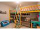 bedroom loft bed with colorful ladder and study area at 18187 W Via Montoya Dr, Surprise, AZ 85387
