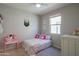 Charming bedroom with a twin bed, vanity and decor at 18187 W Via Montoya Dr, Surprise, AZ 85387