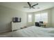 Primary bedroom with ceiling fan, bed, desk, dresser, and two windows at 18187 W Via Montoya Dr, Surprise, AZ 85387