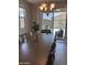 Bright dining room with a chandelier, and sliding doors to the outdoor patio at 18187 W Via Montoya Dr, Surprise, AZ 85387