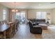 Inviting dining area with a large wooden table, views of the living room, and backyard patio access at 18187 W Via Montoya Dr, Surprise, AZ 85387